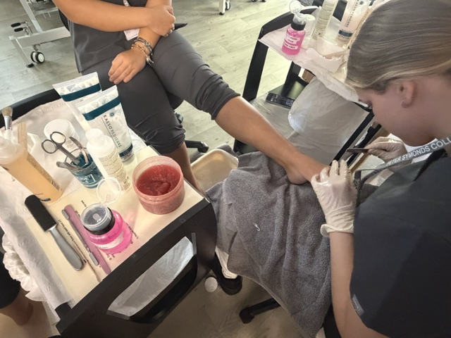 Image of Level 2 Beauty students completing a pedicure treatment in training salons